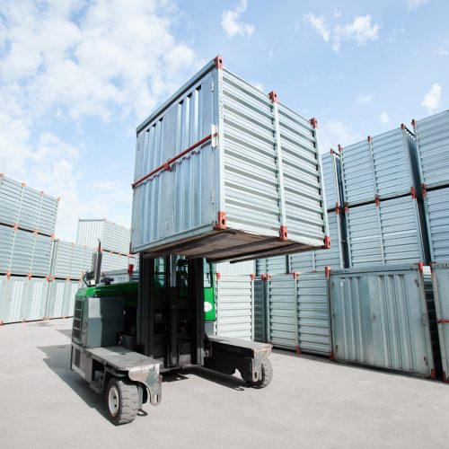 Special machine lifting large and heavy storage container and loading it